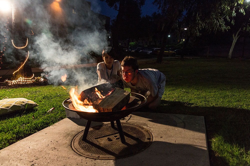 Students outside around a bonfire