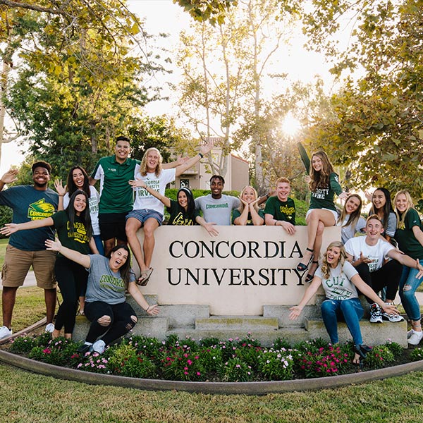Group of students posing in front of Concordia University sign