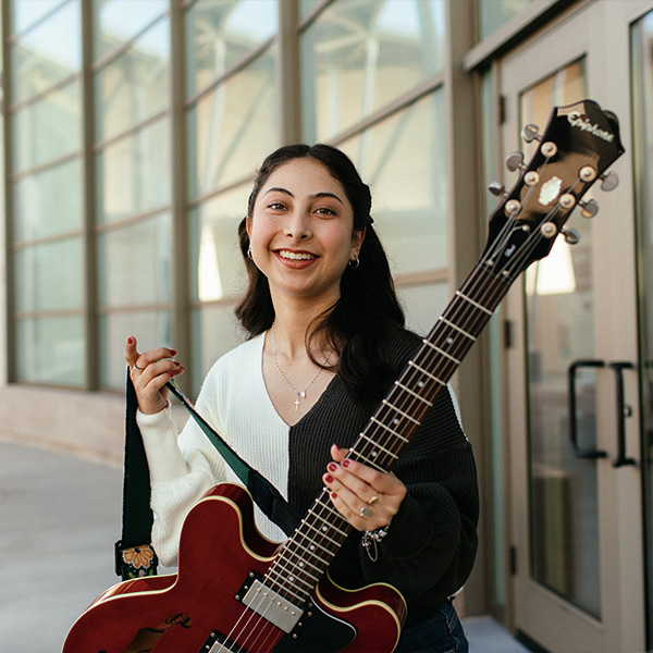 Maria playing her bass guitar