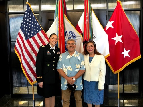 Kelly Guerra in her uniform with her parents