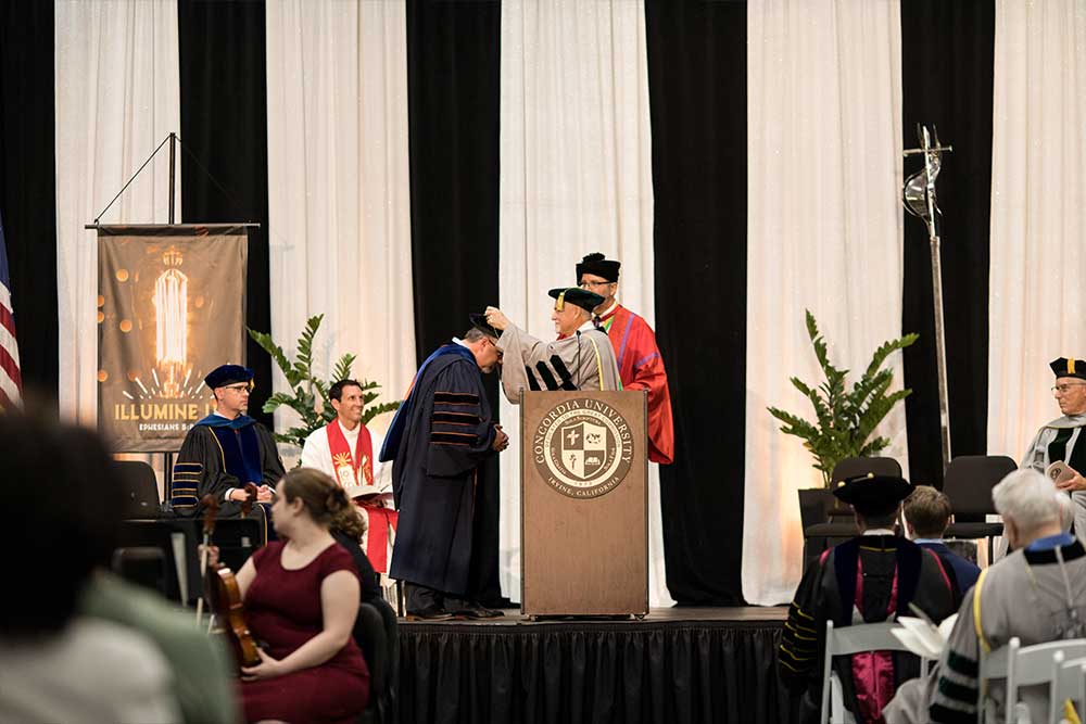 President Thomas being greeted at the podium