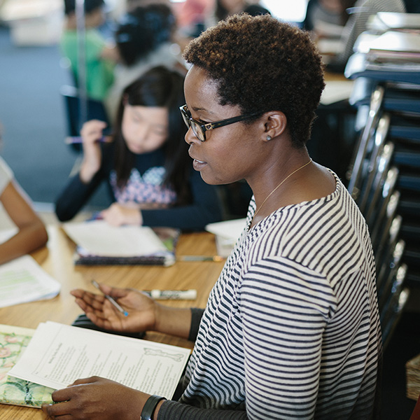 Teacher speaking with students