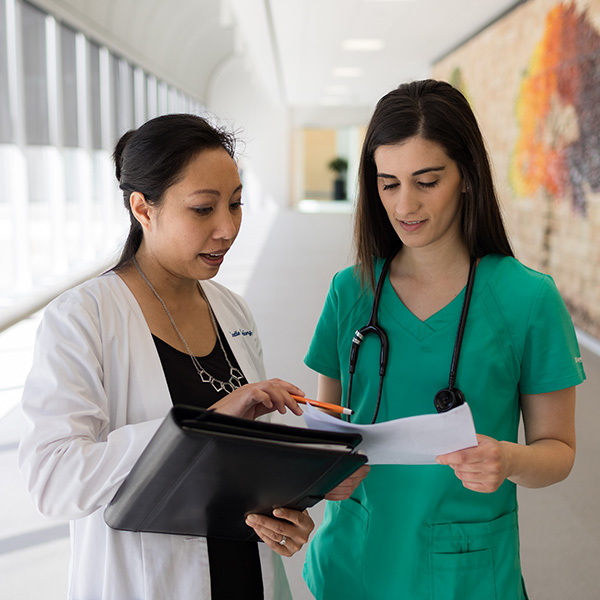 Two females having a conversation in a hospital