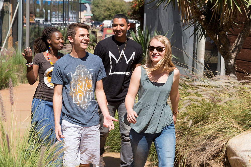 Students walking through a shopping center pathway