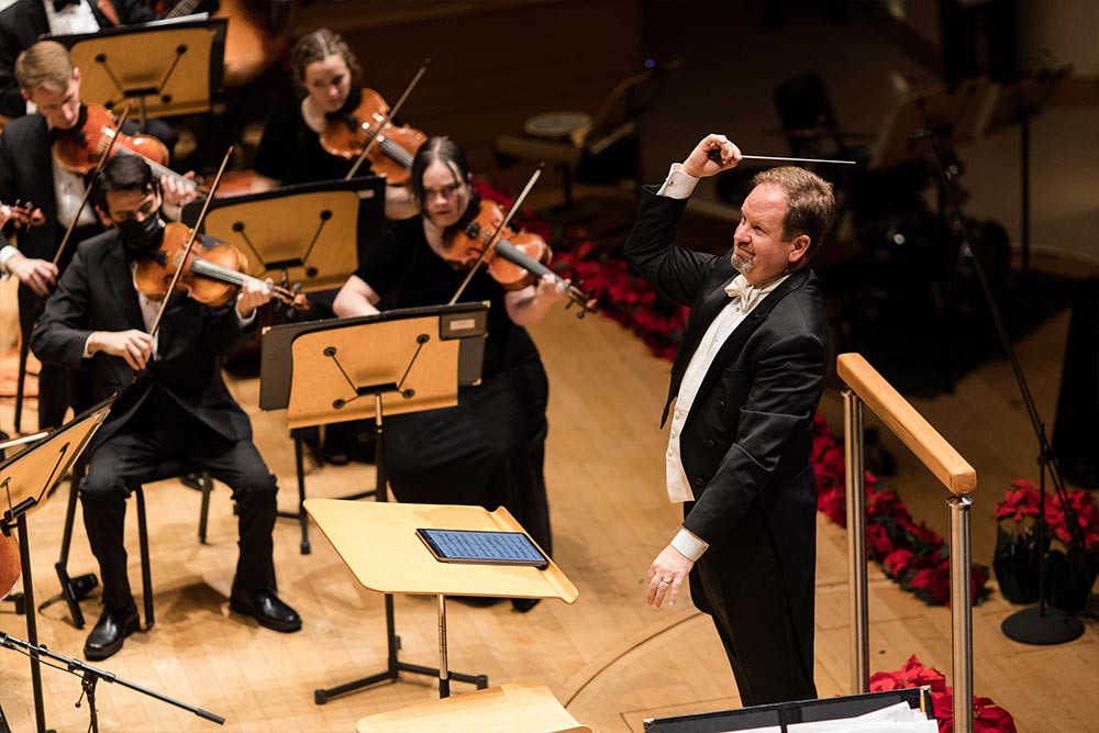 Dr. Michael Busch conducting the orchestra and choir