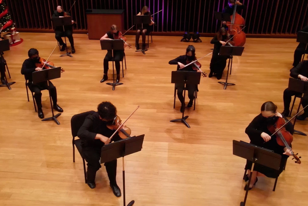 Students performing in orchestral hall