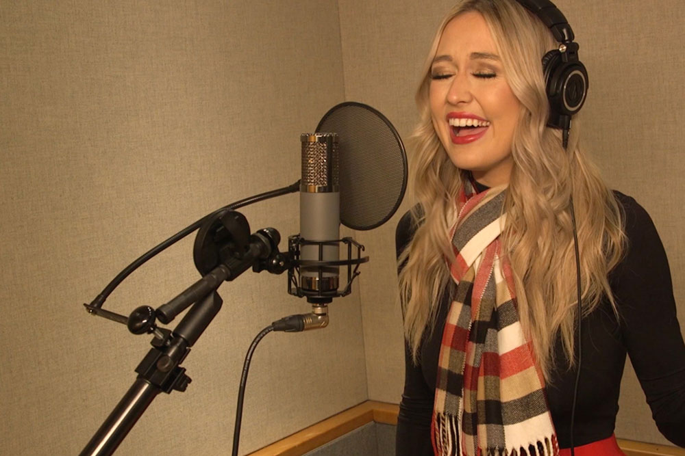 Female singing in recording studio