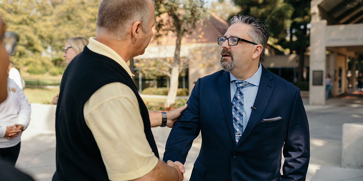 President Thomas with a faculty member