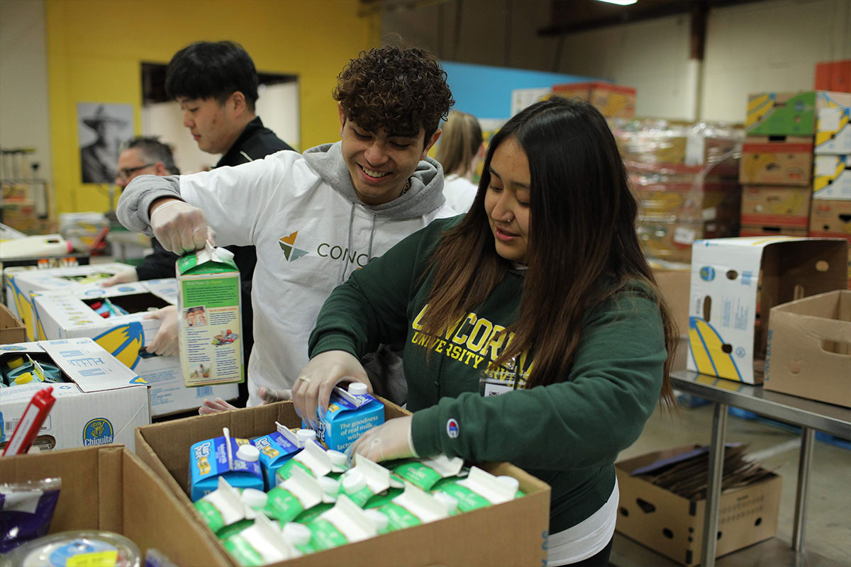 Students packing boxes with food