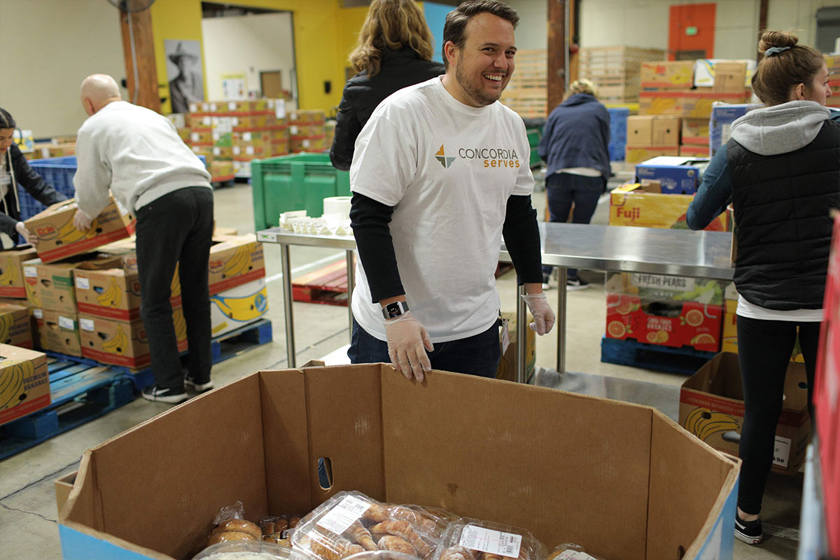 Student packing boxes with food