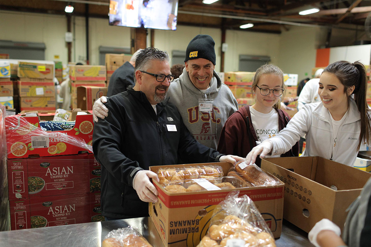 President Thomas volunteering with students