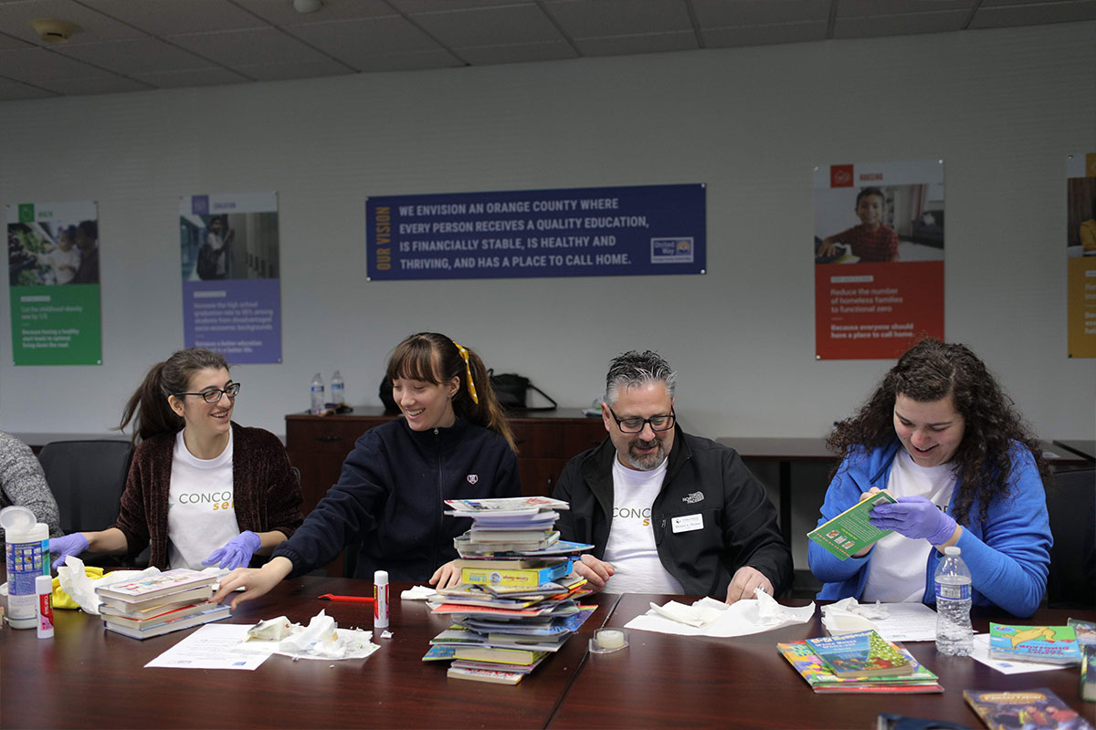President Thomas helping repair books
