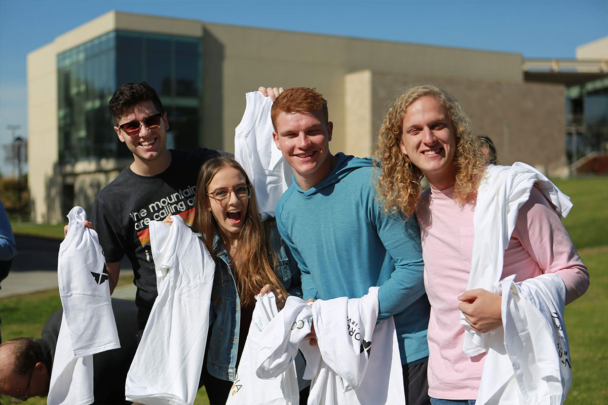 More students posing with their shirts