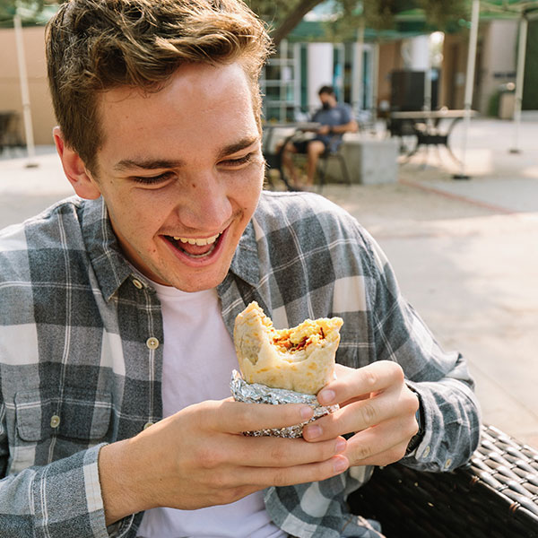 Student eating the famous CUI breakfast burrito