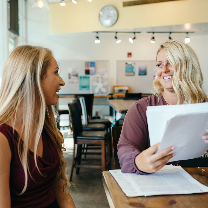 Two females reviewing paperwork