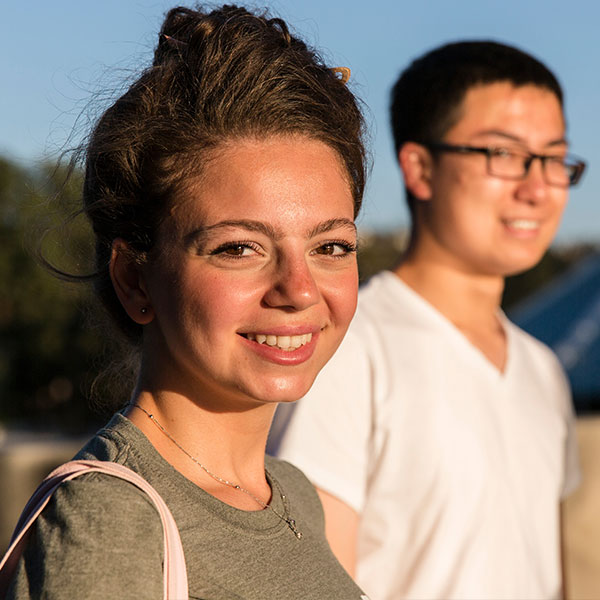 Male and female students in front of Grimm Hall