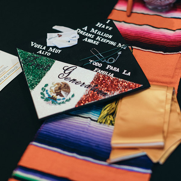 Spanish decorated graduation cap and gown