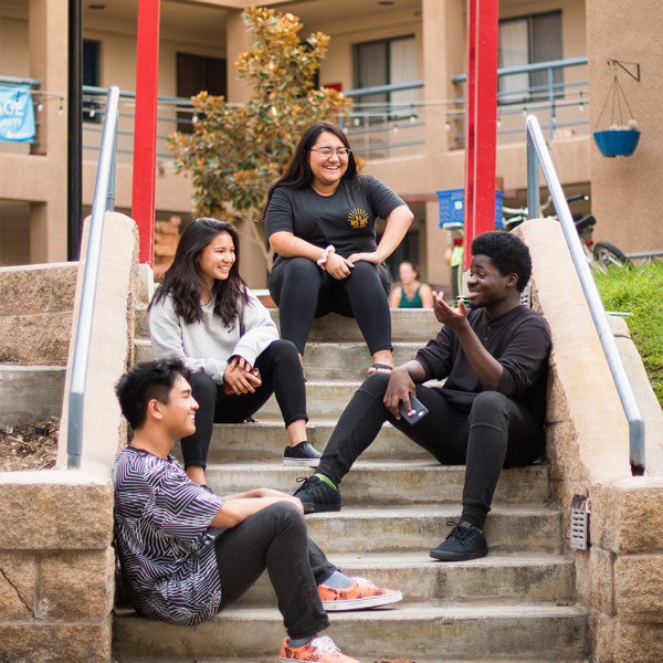 Students chatting on the stairs of Global Village