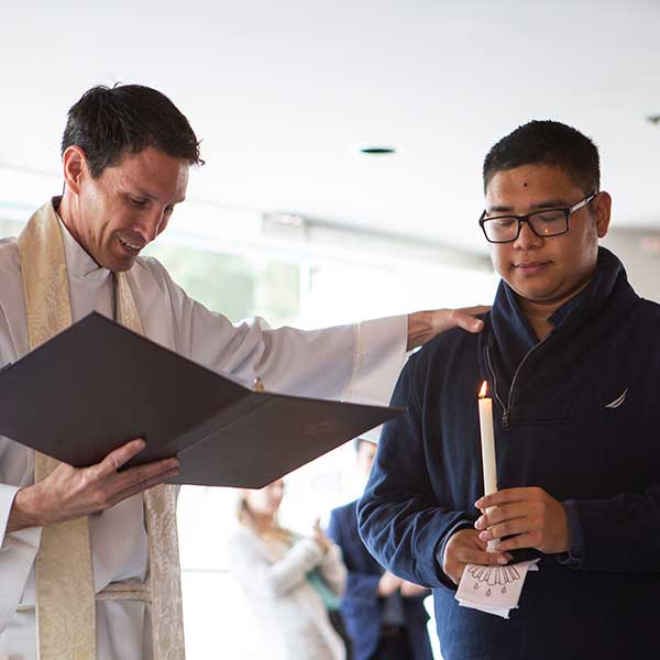 Student preparing to get baptised by campus pastor