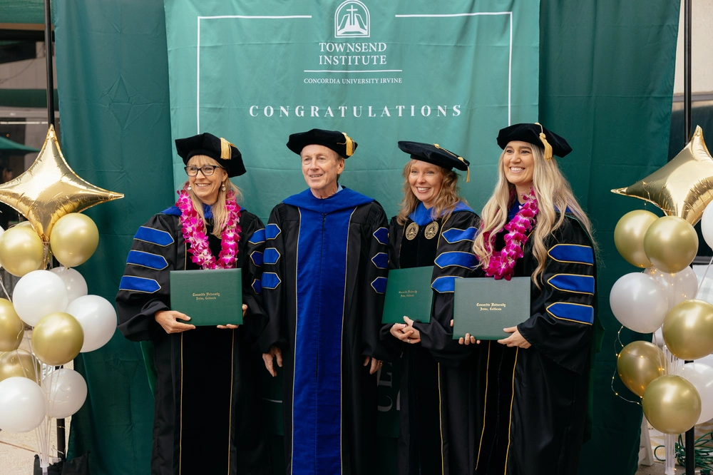 Three woman PhD graduates