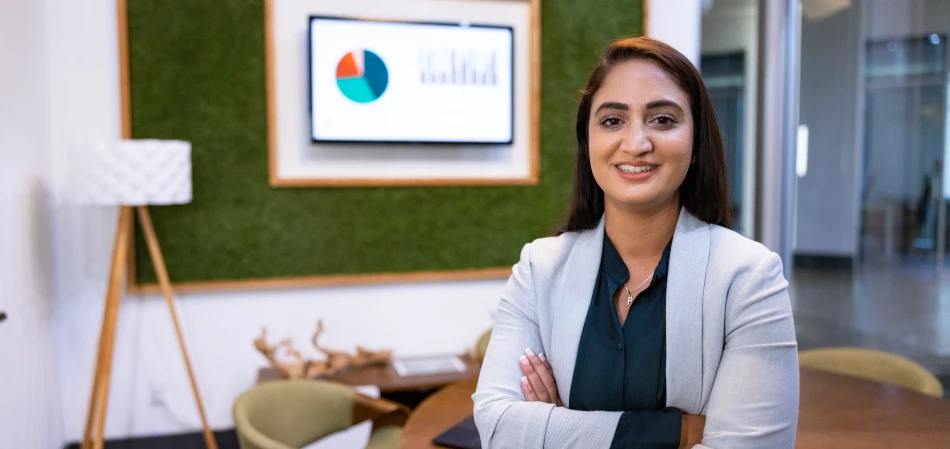 Professional woman smiling in a modern meeting room