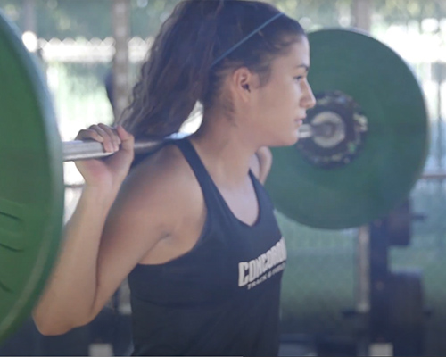 Student athlete lifting weights