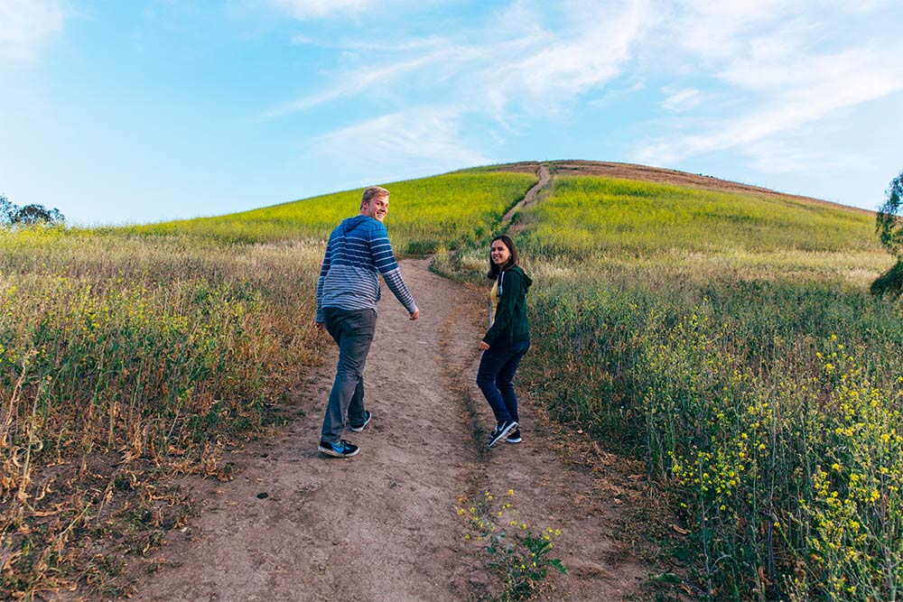 Two Concordia students climb the trail to the top of French Hill.