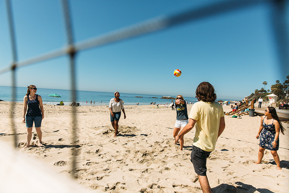 Students enjoy a game of beach volleyball at Laguna Beach.