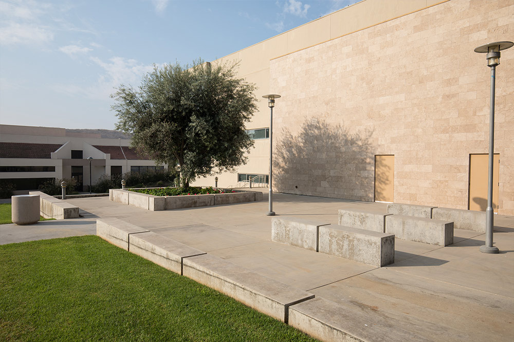  Stone benches provide seating alongside Grimm Hall facing the lawn.