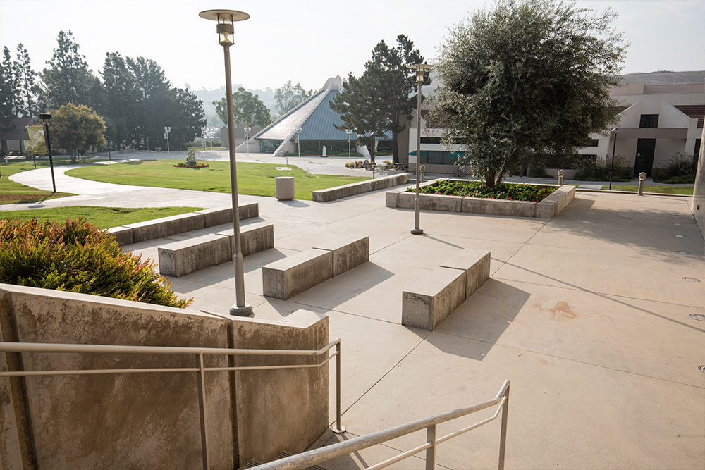 The plaza alongside Grimm Hall connects the Theatre, Arts, and Library building and the CU Center.