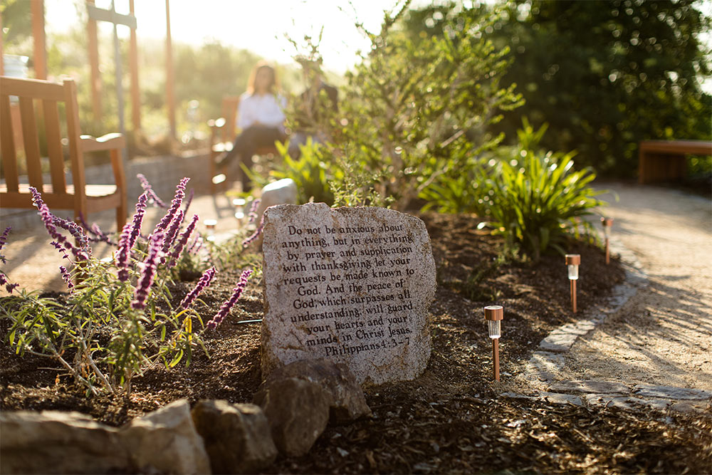 A scripture stone in the Prayer Garden featuring Philippians 4:3-7 