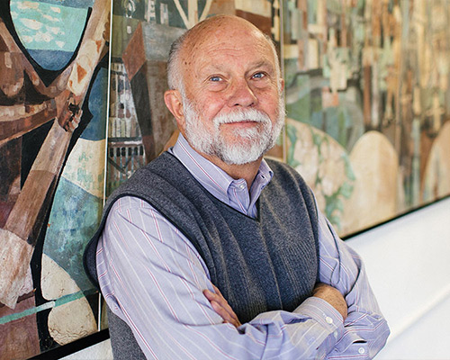 Gerald Brommer standing in front of his mural