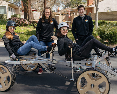 Students posing with the rover