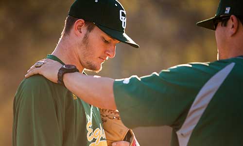 baseball coach giving advice to a player