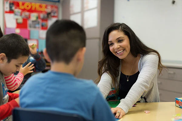 Teacher helping students in the class room