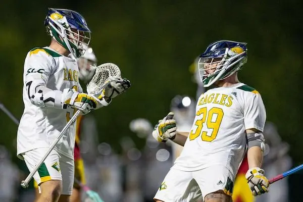 Two lacrosse players cheering