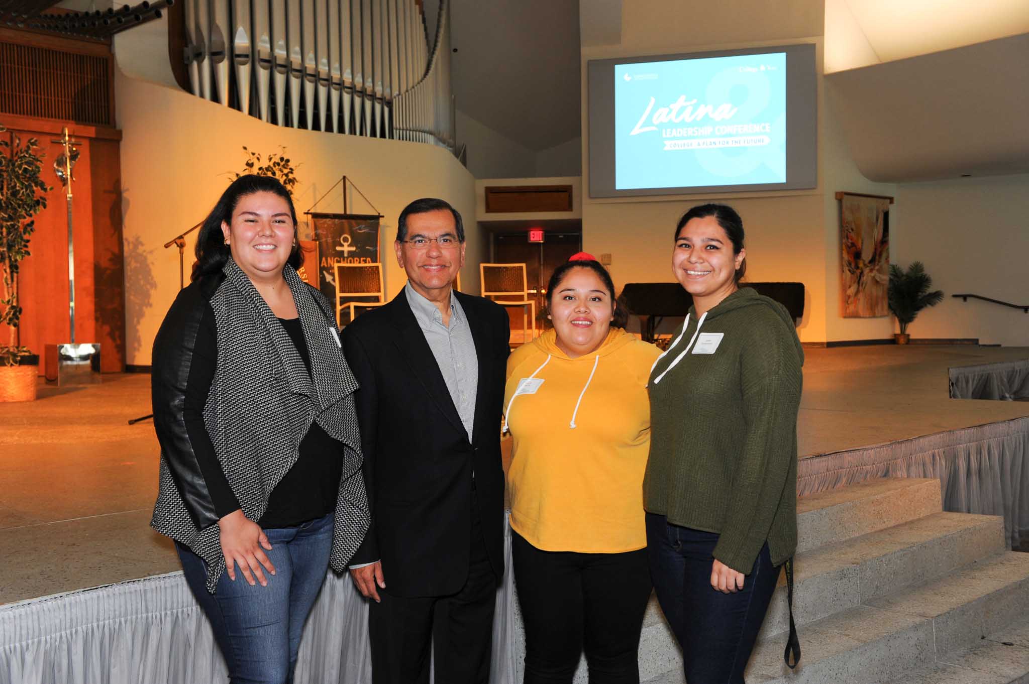 students posing with Ambassador Gaddi Vasquez