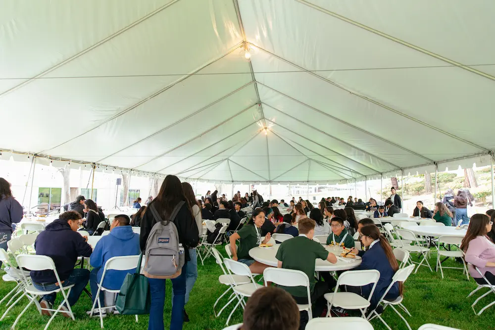 Attendees under a tent