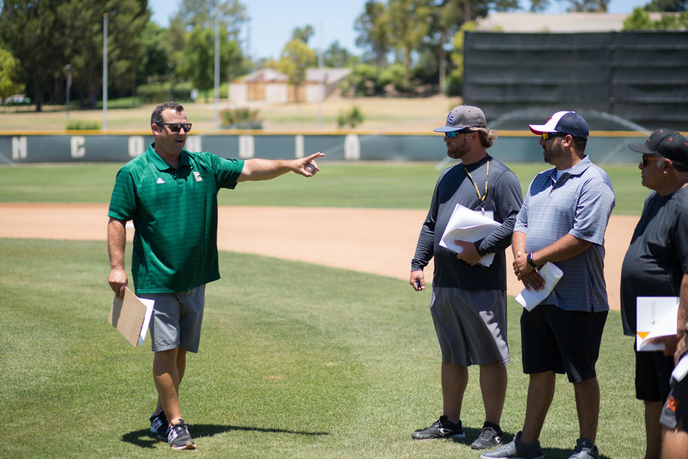 Baseball coach giving a lesson on the baseball field