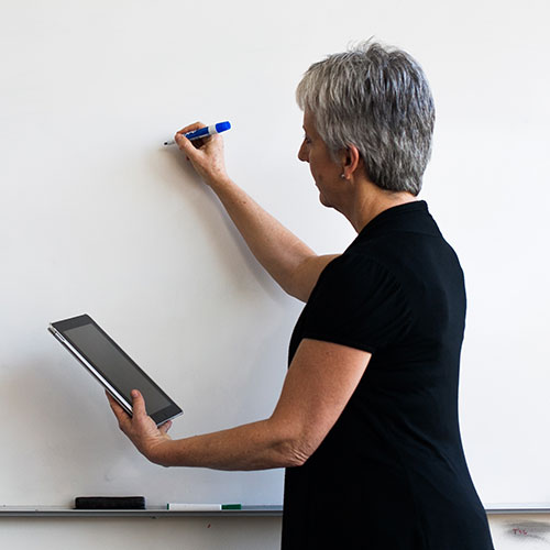 teacher using a tablet in the classroom