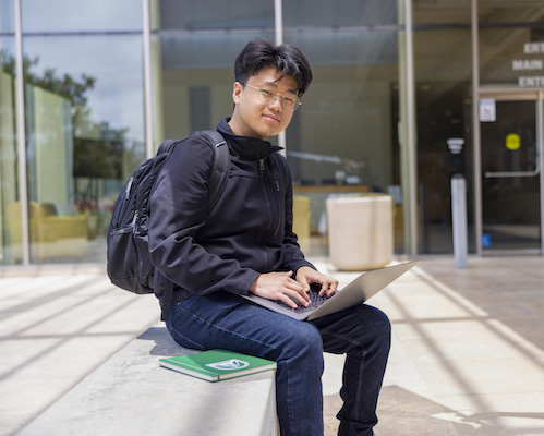 Student sitting with laptop