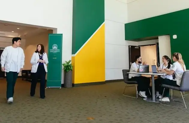 Nursing students and faculty in new building hallway