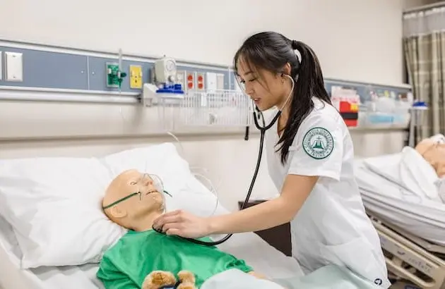 Nursing student practicing on dummy