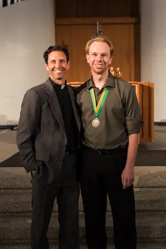 Celebration of Ministry attendee with award standing next to pastor