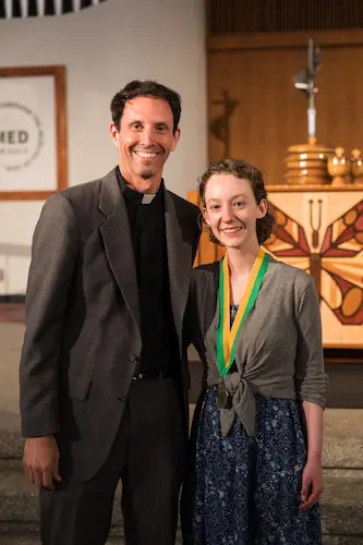 Celebration of Ministry female attendee with award next to pastor