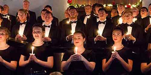 Choir members holding candles