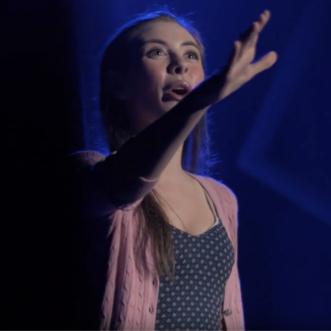 close up of female student acting on stage