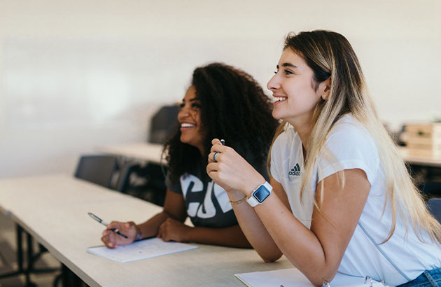 Two female students in a classroom