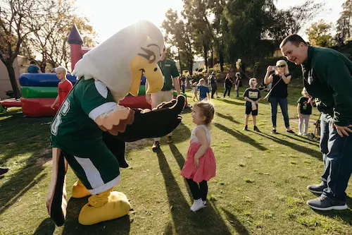 Concordia mascot playing with child