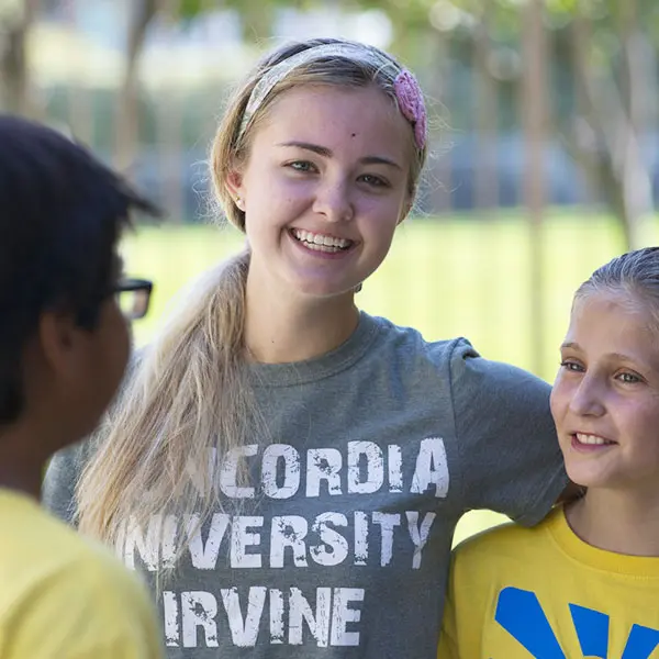 DCE student talking with kids